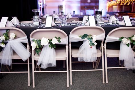 covering a grey metal chair with fabric for reception|diy wedding chair decoration.